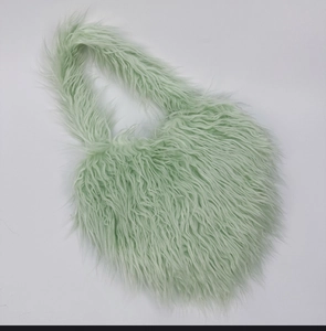 Detailed view of mint green long faux fur shoulder bag with soft plush texture