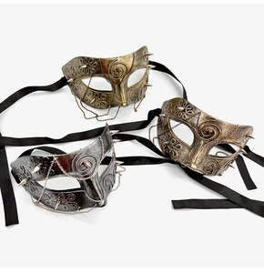 Close-up of vintage steampunk half face masks with metallic chains and rivets