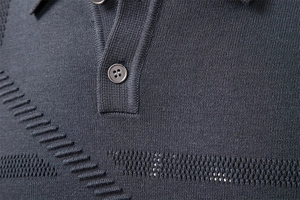 Close-up of polo shirt collar with resin buttons and dark grey knit texture detail