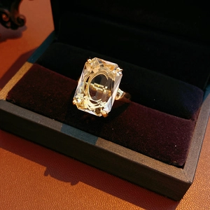 Macro shot of a 14k gold plated square zircon ring set in a luxury black velvet box