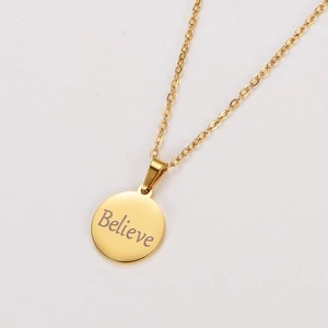 Detail view of 18k gold stainless steel round pendant with Believe engraving and O-chain