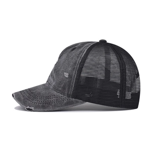 Side view of distressed washed denim baseball cap with vintage frayed holes and mesh back