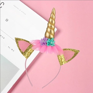 Glittery unicorn headband with gold horn and silk flowers for birthday party supplies