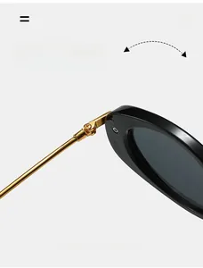 Macro view of durable metal hinge on retro oval sunglasses with black frames