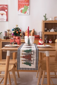 Detail of Christmas table runner with Merry & Bright text and black white plaid border