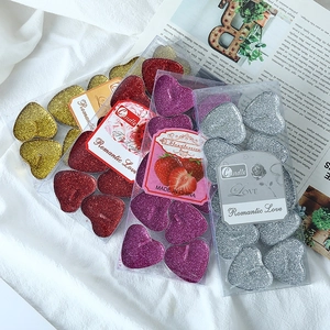 Glitter heart-shaped tea light candles in gold and red for romantic decor