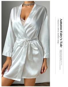 Detailed view of the elegant white satin robe featuring a delicate tie-waist and V-neckline