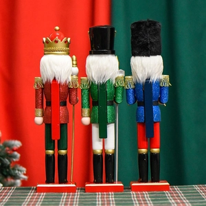 Three 38cm wooden nutcracker soldiers with red, green and blue glitter on festive background