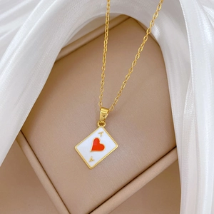 Golden Ace of Hearts pendant necklace with luxury rhinestones on a silk background
