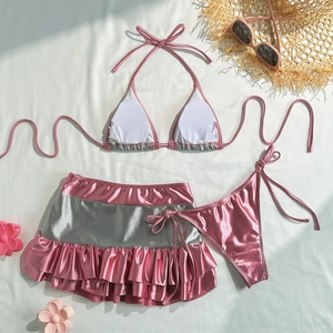 Detail of three-piece metallic pink and silver bikini set with ruffled skirt