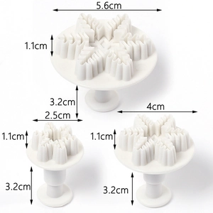 Three-piece snowflake plunger cutter set in white plastic with precise size markings