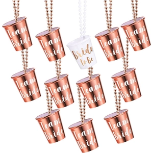 Close-up of 12 plastic shot glass necklaces for hen parties in rose gold and white