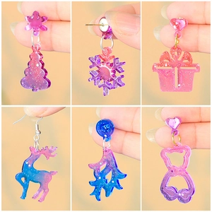 Glittery DIY Christmas resin earrings featuring snowflakes, reindeer and tree designs