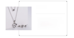 Close-up of titanium steel set featuring LOVE engraved heart pendant and ball earrings