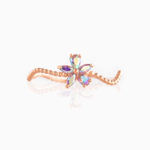 Macro detail of rose gold flower ring with wavy beaded band and colorful teardrop crystals