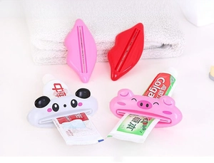 Macro view of cute cartoon animal toothpaste squeezers including panda and pig shapes