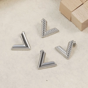 Polished silver V-shaped stud earrings with textured honeycomb pattern in stainless steel