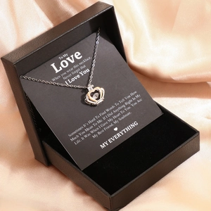Detail of crown heart necklace with elegant gift box and romantic message card set