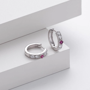 Detailed macro view of S925 sterling silver hoop earrings with red square zircon inlay