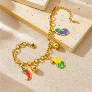 Gold chain bracelet featuring colorful enamel vegetable charms and small golden bells