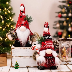 Christmas gnomes figurines with knitted hats and candy canes for festive holiday decoration