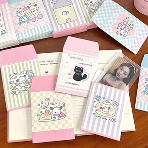 Detailed close-up of cute cartoon envelopes for photo cards on a vintage notebook
