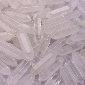 Close-up of double-pointed clear crystal hexagonal pillars in a dense pile
