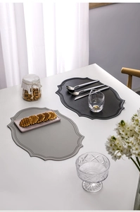 Close-up of heat-resistant faux leather placemats in dark and light grey for dining decor