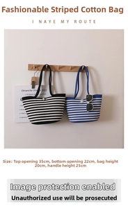 Detail of woven striped tote bag with pearl closure and specific size measurements