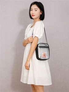 Detail view of transparent PVC crossbody bag showing capacity with cosmetics inside