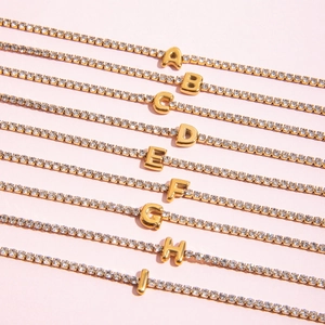 Macro shot of 18K gold plated tennis bracelets with sparkling A-I bubble letters