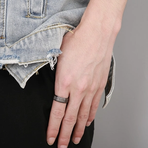 Macro shot of industrial grid texture on retro dark silver titanium steel ring for men