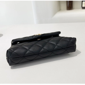 Detail view of the black quilted PU leather base with gold-tone hardware and stitching