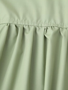 Macro view of pea green woven fabric showing fine stitching and natural textures