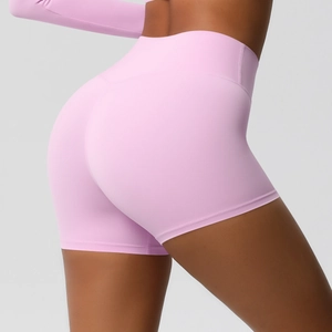 Close-up of high-waisted pink yoga shorts featuring a peach lift seam and stretchy fabric
