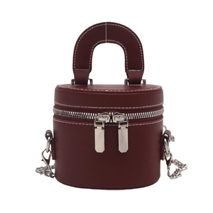 Vintage burgundy cylindrical mini crossbody bag with white stitching and silver chain