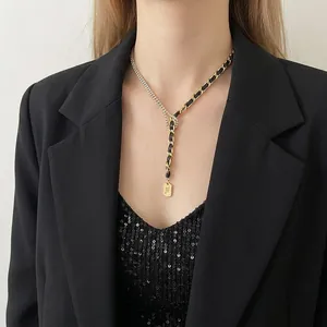 Exaggerated Y-shaped rhinestone gold chain necklace with woven black leather strap