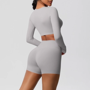Detail of lavender two-piece yoga set featuring long sleeve crop top and high waist shorts