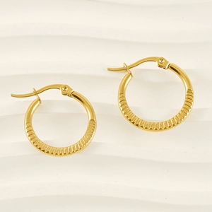 Polished gold stainless steel hoop earrings with elegant radial stripes and hinge closure