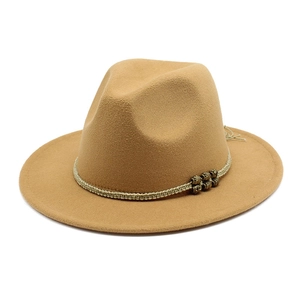 Detailed macro view of camel wool fedora hat with braided band and vintage metal beads