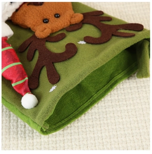 Close-up of green felt Christmas gift bag featuring 3D plush reindeer with holiday hat