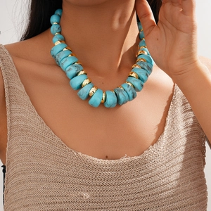 Detail of chunky turquoise acrylic beads and gold metal spacers on adjustable necklace