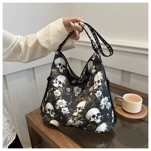Close-up of a black nylon crossbody bag featuring gothic skull and white floral prints