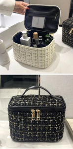 Detail of tweed makeup bag with gold zipper showing interior mesh pocket and handle