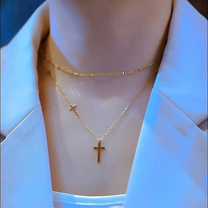 Close-up of 18K gold-plated double-layer necklace with cross pendants on model