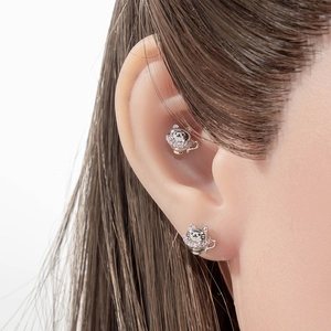 Micro-inlaid zircon teacup cat stud earrings in silver metal worn by a model
