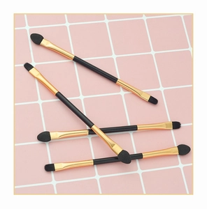 Detail view of 4 dual-ended eyeshadow brushes with black handles and gold ferrules