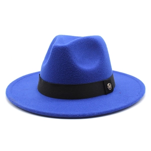 Detail of royal blue wool fedora hat featuring black ribbon and gold M metal buckle