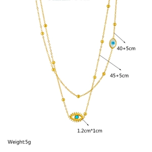 Double-layer gold stainless steel chain necklace with blue evil eye charms and metal beads