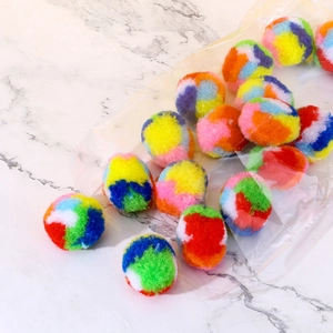 Colorful plush rainbow cat toy balls in assorted bright colors on marble background